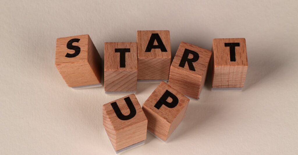 Wooden blocks spelling 'START UP' on a neutral background, symbolizing new beginnings.